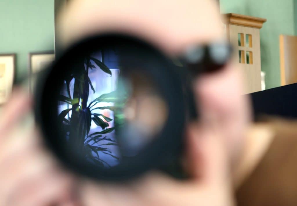 man with camera lense pointed at you
