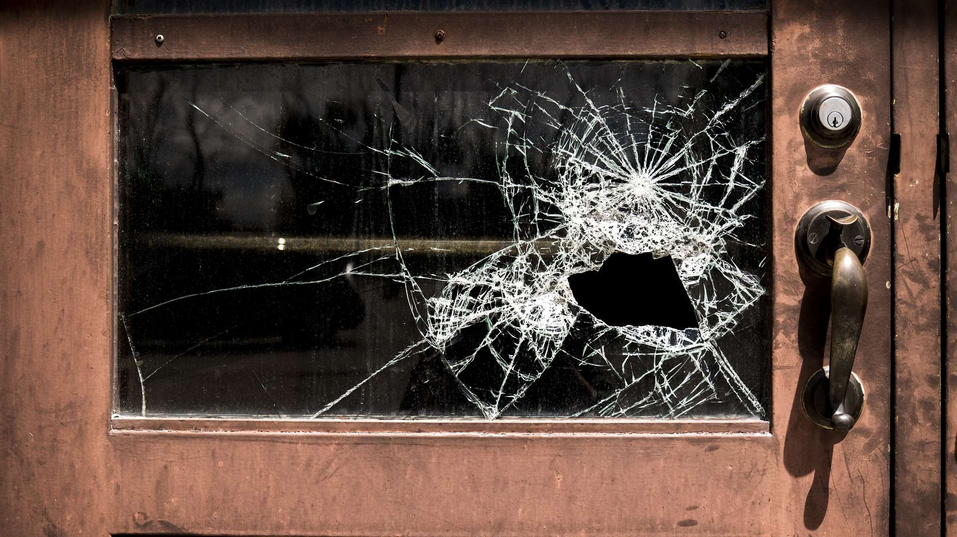 Broken window in a school door